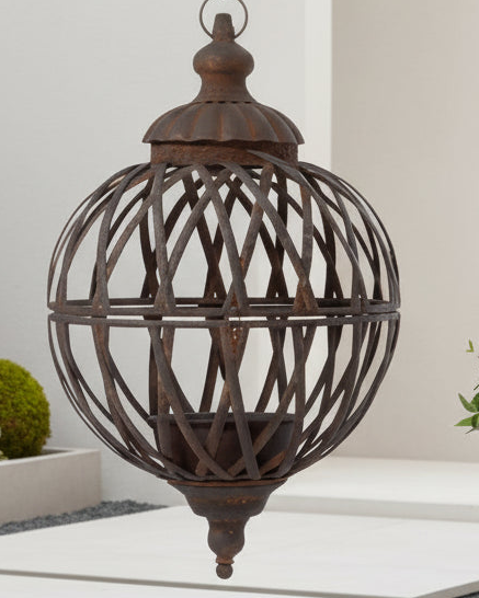 Rusty metal lattice ball planters hanging outdoors, designed for decorative use and crafted by Wikholmform.