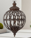 Rusty metal lattice ball planters hanging outdoors, designed for decorative use and crafted by Wikholmform.