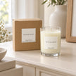 Heaven Scent Winter Scent Medium Candle, unlit with its brown kraft box on a cream console