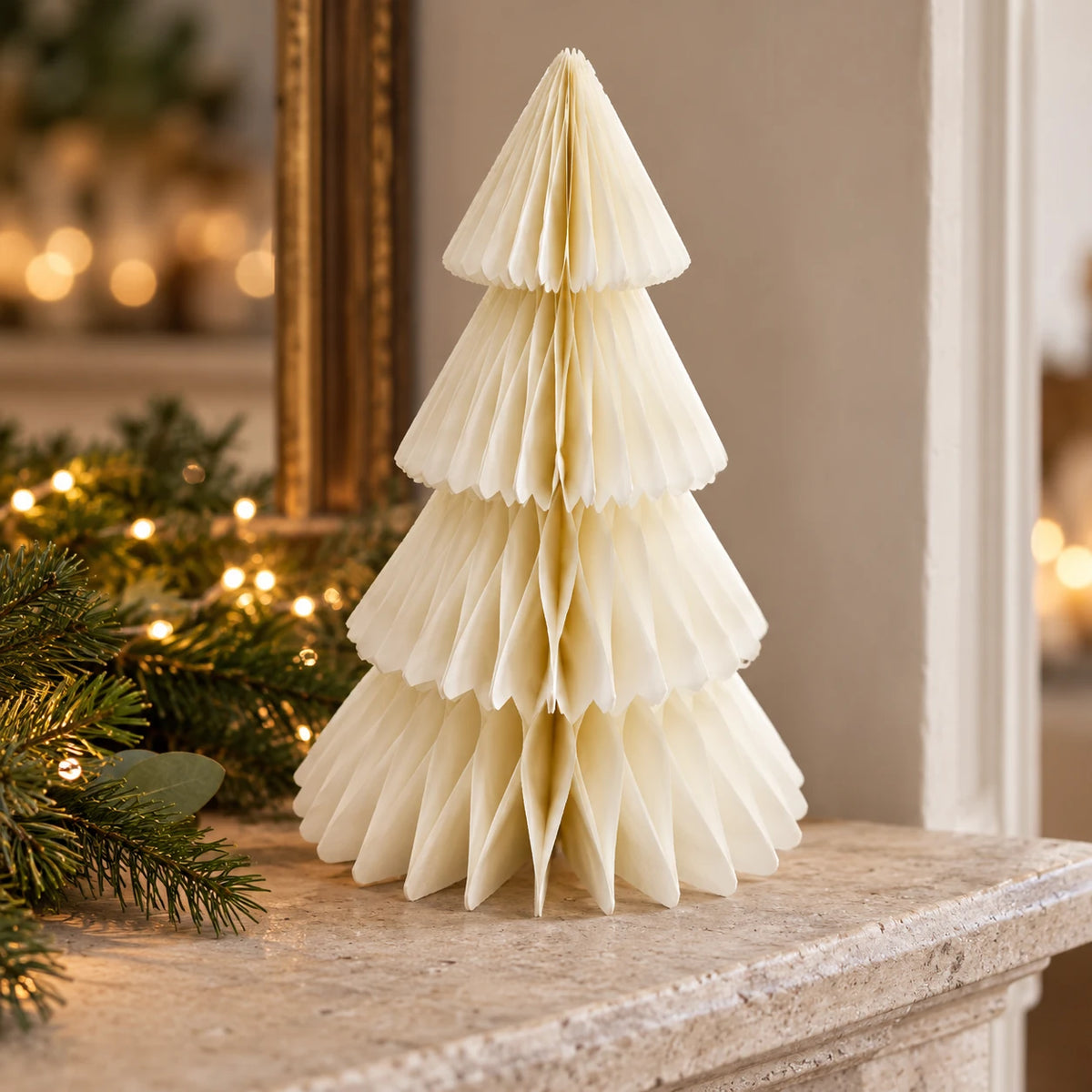 Winter White Paper Christmas Tree on a stone mantel with Christmas greenery