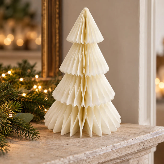 Winter White Paper Christmas Tree on a stone mantel with Christmas greenery