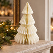 Winter White Paper Christmas Tree on a stone mantel with Christmas greenery