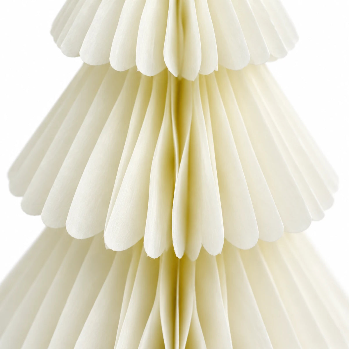 Close-up of the layered tiers and folded paper edges on a winter white paper Christmas tree.