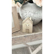 Wooden House Ornament - Beige Moments Keep A Place In Your Heart, close view of the beige house ornament beside a vase
