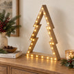 Large wooden LED nested tree on an oak console.
