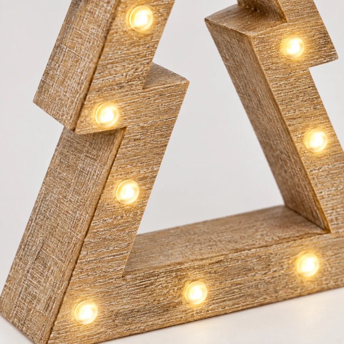 Close-up of original small tree embedded LEDs and wood surface on Wooden Light Up Led Nested Tree.