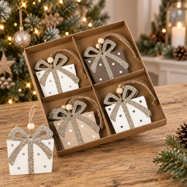 Boxed wooden present hanging decorations on an oak table.