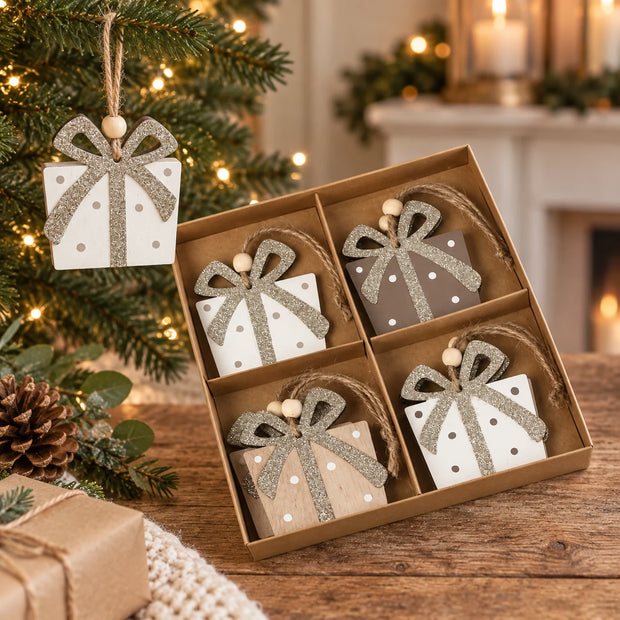 Cream wooden present decoration hanging on a Christmas tree.