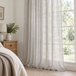 Yard greige sheer voile curtain panel styled beside a country bedroom window