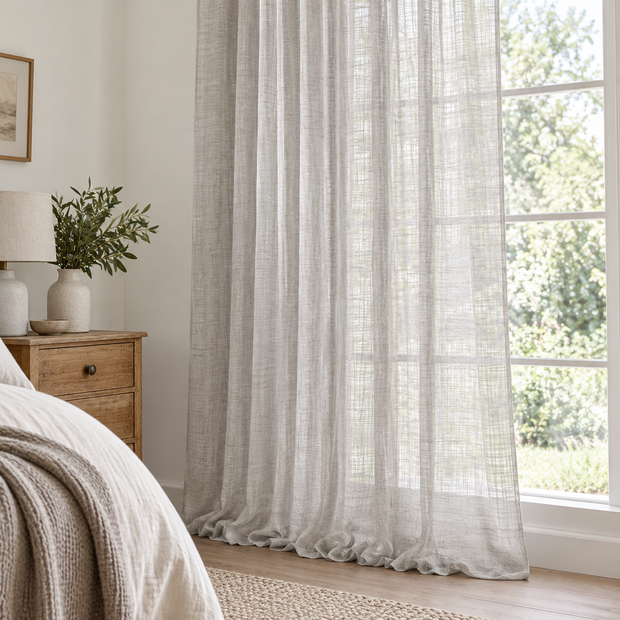 Yard greige sheer voile curtain panel styled beside a country bedroom window