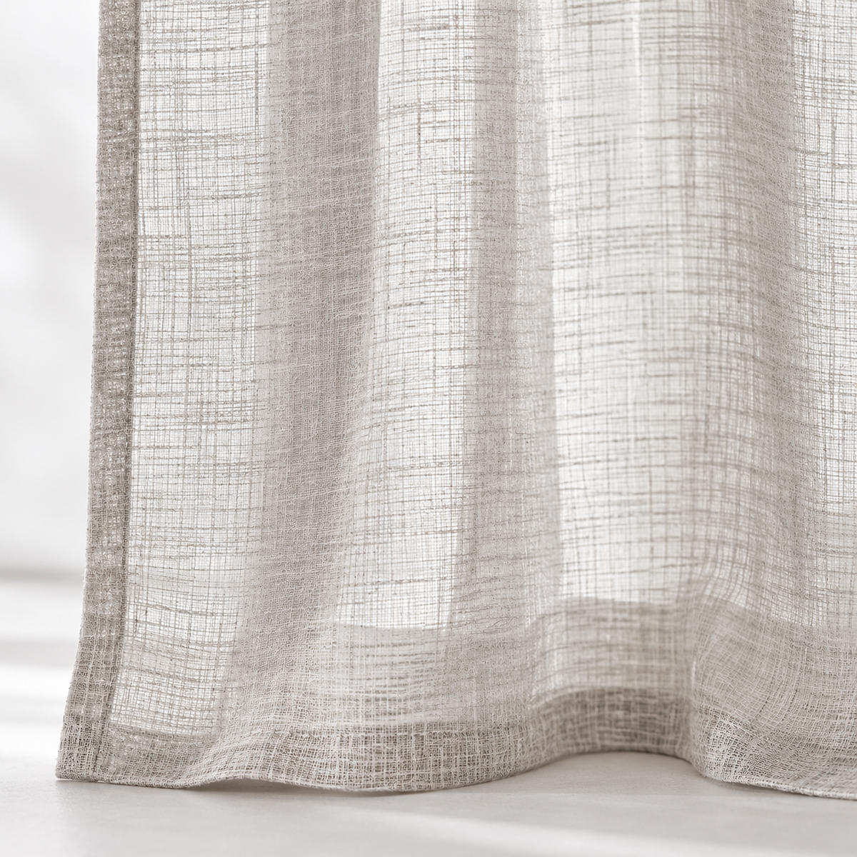 Yard greige sheer voile curtain panel close-up of the fabric hem and edge