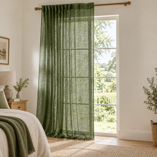 Yard olive green sheer voile curtain panel styled beside a country bedroom window