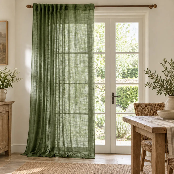 Olive green woven sheer voile curtain panel from Riva Home hanging in a styled dining room, adding soft, elegant window coverage.
