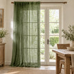 Olive green woven sheer voile curtain panel from Riva Home hanging in a styled dining room, adding soft, elegant window coverage.