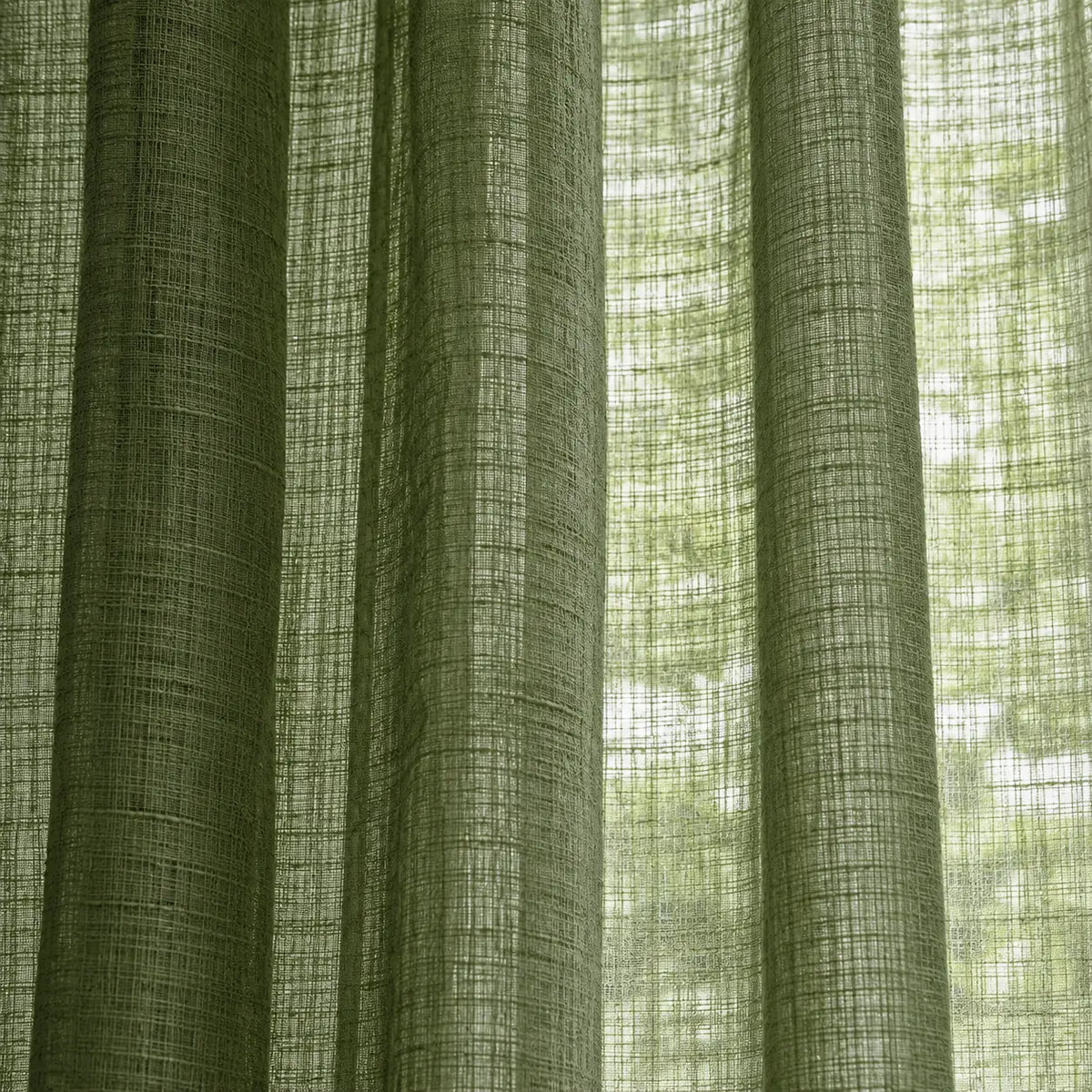 Olive green woven sheer voile curtain panel with hanging folds, soft furnishings by Riva Home.