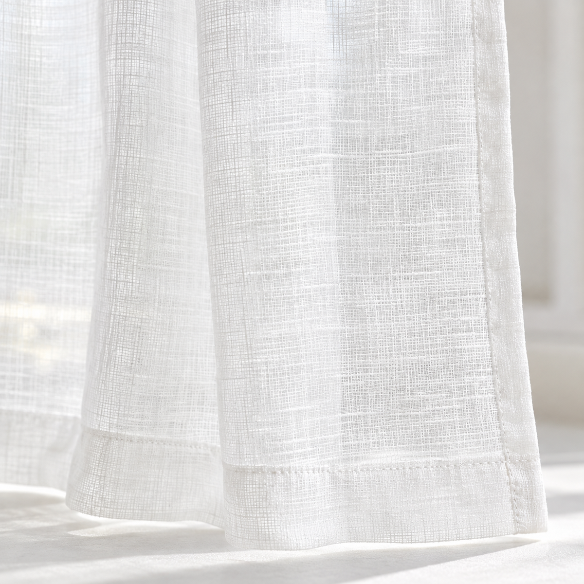Yard white sheer voile curtain panel close-up of the fabric hem and edge
